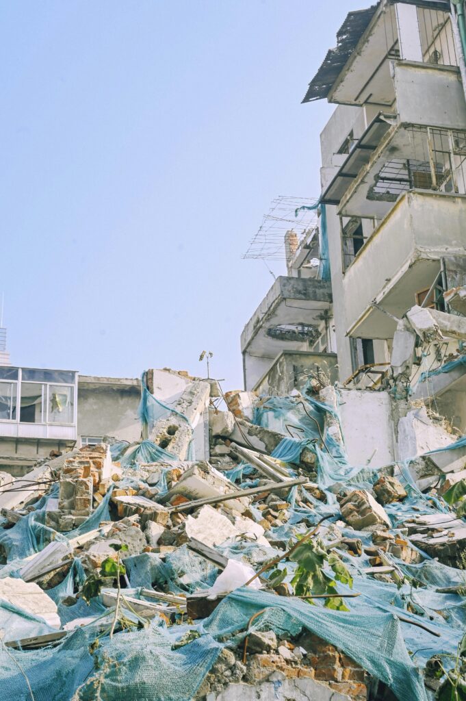 Demolished urban building with rubble and debris, showcasing construction dismantling.