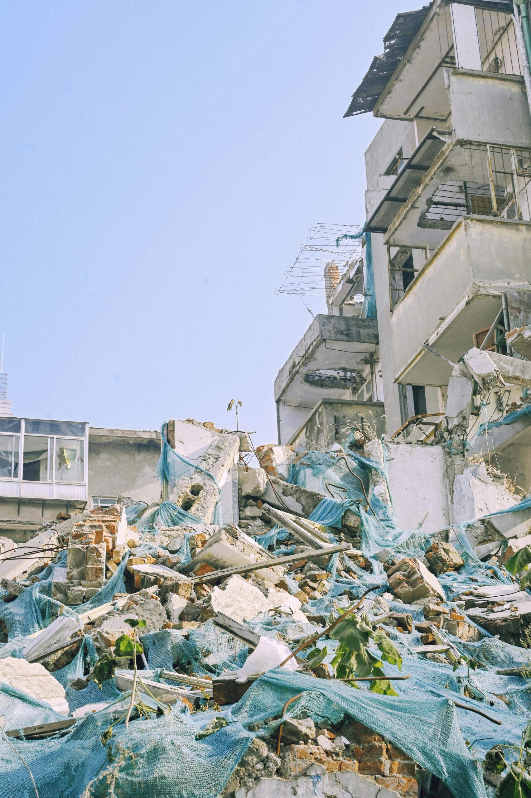 Demolished urban building with rubble and debris, showcasing construction dismantling.